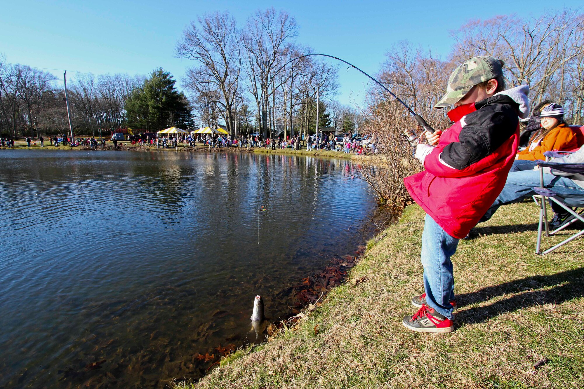 Sawyer Budai, 7, catches a trout during the Kiddie Fishing Derby on Laurel Pond at Joint Base McGuire-Dix-Lakehurst, N.J., April 6, 2013. The fishing derby is an free annual  trout fishing contest for children on the opening day of trout fishing. (U.S. Air Force courtesy photo/Released)