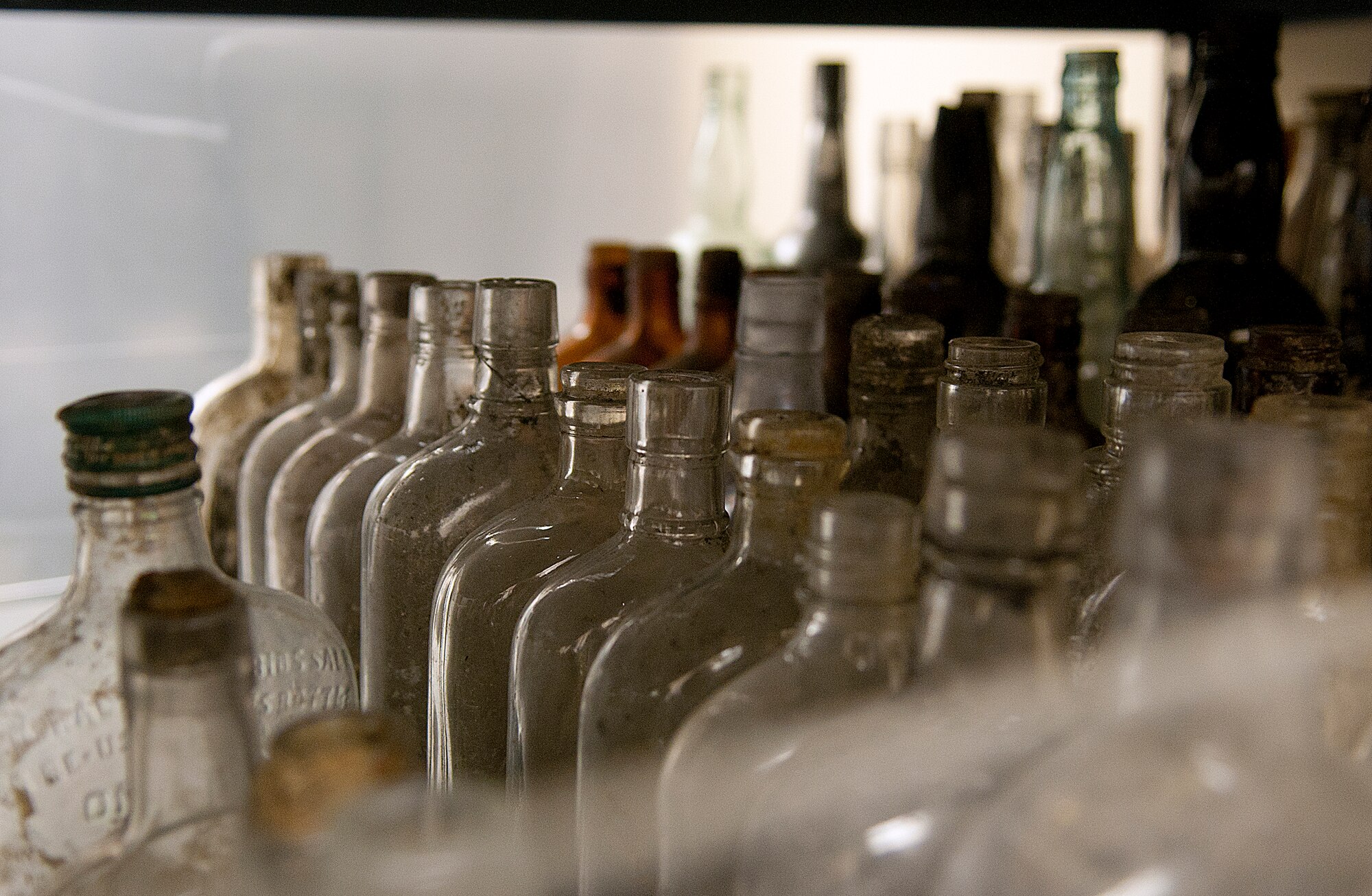 Rows of antique bottles line a shelf in the F. E. Warren Air Force Base curation facility known as “the bunker.” Artifacts from the approximately 200 archeological digs on the base are stored in the climate controlled facility. (U.S. Air Force photo by R.J. Oriez)