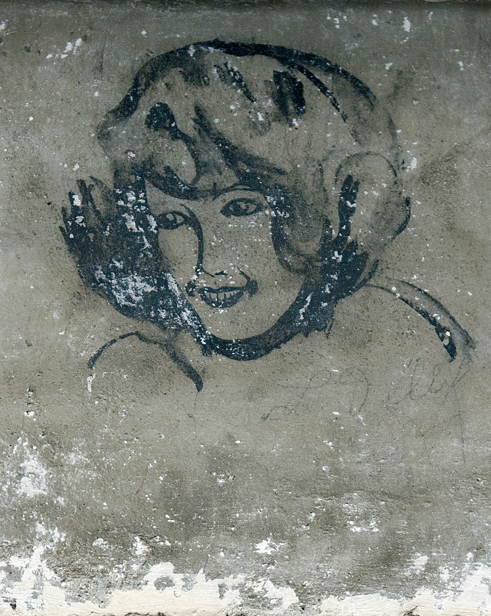 A sketch of a young woman looks down from the cement wall over the door into the F. E. Warren Air Force Base curation facility known as “the bunker.” The artwork, believed to have been drawn sometime around 1920, is just one of many pieces of graffiti discovered as decades of paint was stripped from the walls when an old potato storage cellar was converted into a state-of-the-art archive for historical documents and artifacts. (U.S. Air Force photo by R.J. Oriez)