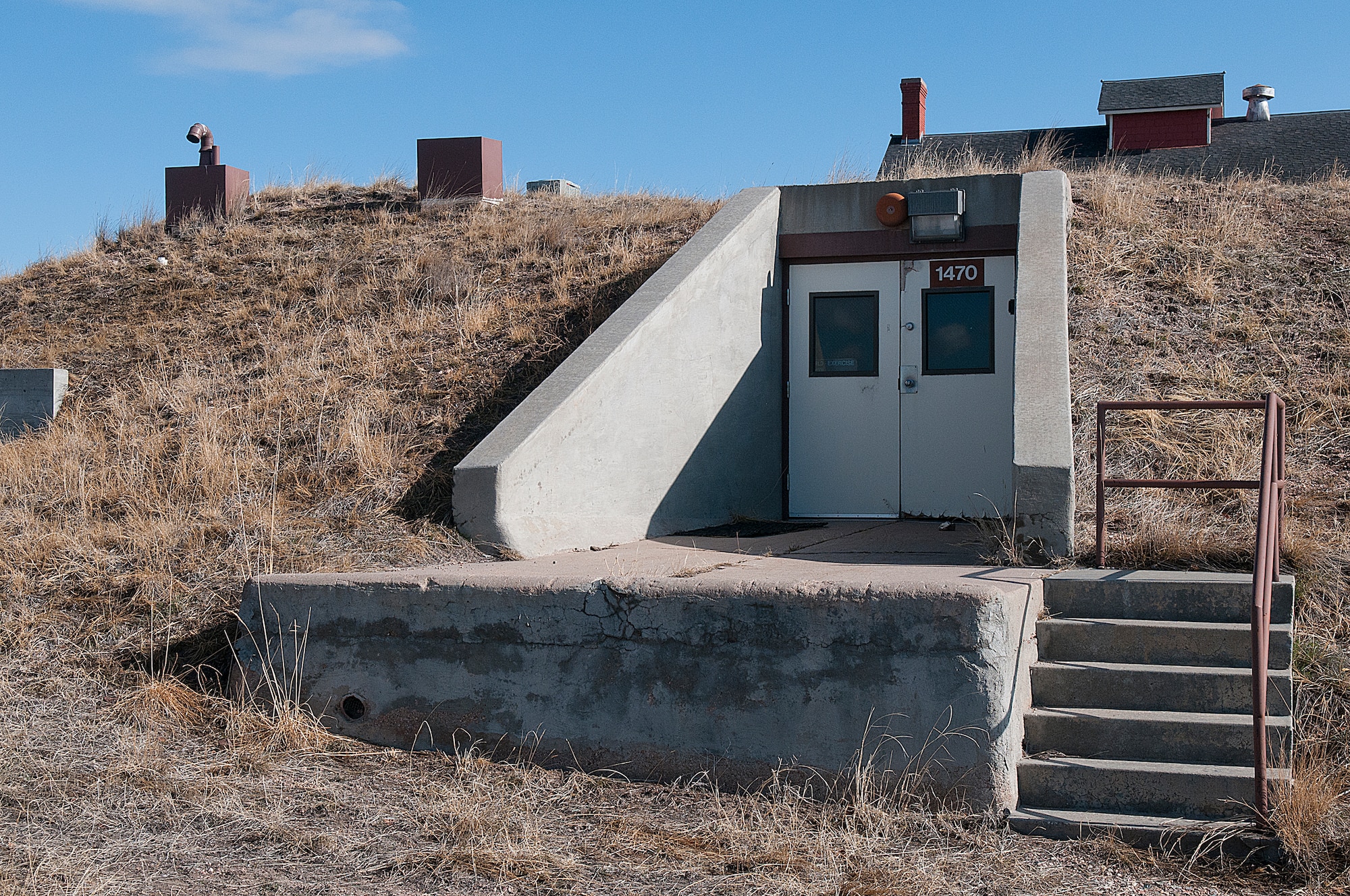A doorway leads to the underground curation facility, known as “the bunker” on F. E. Warren Air Force Base. The structure, originally built around the turn of the last century for the storage of potatoes, is a climate-controlled facility for the storage of historical documents and artifacts. (U.S. Air Force photo by R.J. Oriez)