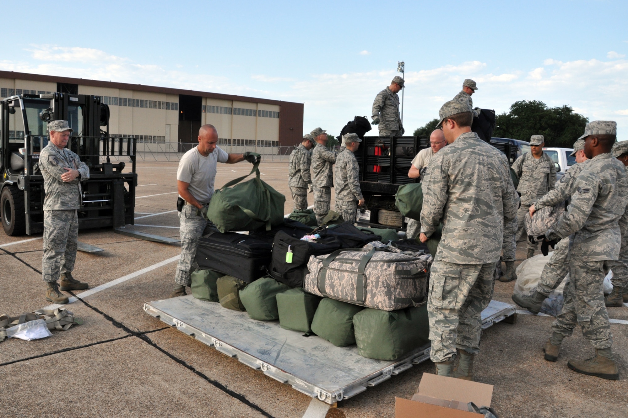 U.S. Air Force Master Sgt. Jackie Kirkwood, NCOIC Chapel Services, 307th Bomb Wing, supervises a group of Air Force Chaplain Candidates and several Airmen from the 2nd Bomb Wing, as they palletize luggage in the Hoban Hall parking lot at Barksdale Air Force Base, La., Aug. 2, 2012. Barksdale was the second stop for the 28 candidates as part of The Chaplain Candidate Intensive Internship, which is a program designed to provide a structured opportunity for students to test their call and suitability for service as Air Force chaplains. The candidates were at Barksdale from July 27 to Aug 2, 2012. The CCII program exposes the candidates to what the Air Force is all about. (U.S. Air Force photo by Master Sgt. Jeff Walston)