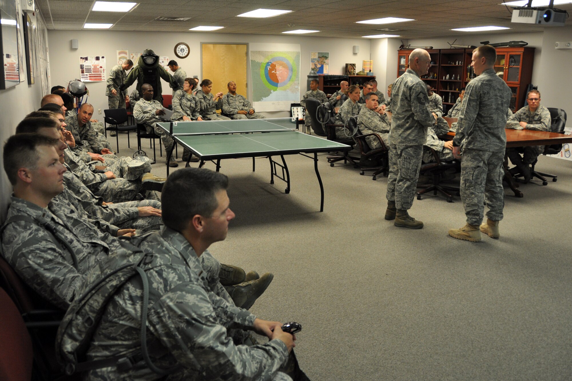 U.S. Air Force Master Sgt. Jackie Kirkwood, NCOIC Chapel Services, 307th Bomb Wing, speaks with Capt. Chad Hogue, commander of the 2nd Civil Engineer Squadron, Explosive Ordinance Disposal Flight, before he briefs a group of Chaplain Candidates in the EOD training room at Barksdale Air Force Base, La., July 31, 2012. A tour of the EOD complex was part of The Chaplain Candidate Intensive Internship program’s visit to Barksdale from July 27 to Aug 2, 2012. (U.S. Air Force photo by Master Sgt. Jeff Walston)