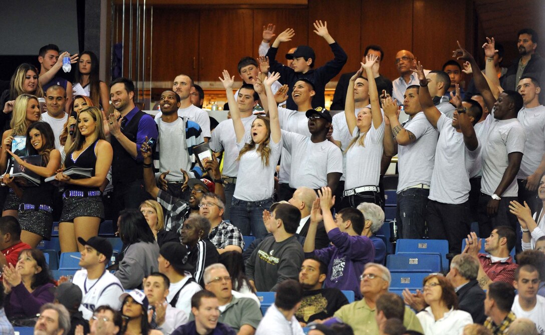 Beale Airmen celebrate their appearance on the big screen at the Sleep Train Arena, April 5, 2013, during a Sacramento Kings game against the Dallas Mavericks. The Airmen were able to meet Mavericks forward and prior Beale Airman Bernard James before the contest. (U.S. Air Force photo by Airman 1st Class Drew Buchanan/Released)