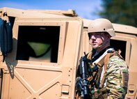 Senior Airman Aaron Bradley, of the 919th Security Forces Squadron, guards the perimeter of a HMMWV during an extraction exercise at Duke Field, Fla., April 6. The Security Forces Airmen executed this training exercise with the trainees from the Development and Training Program. The DTP is an Air Force Reserve Command introductory program to help recruits prepare for military life prior to going to basic military training. The trainees were given a first-hand view of the procedures performed to recover American personnel from a downed aircraft in a hostile environment. (U.S. Air Force photo/Tech. Sgt. Samuel King Jr.)