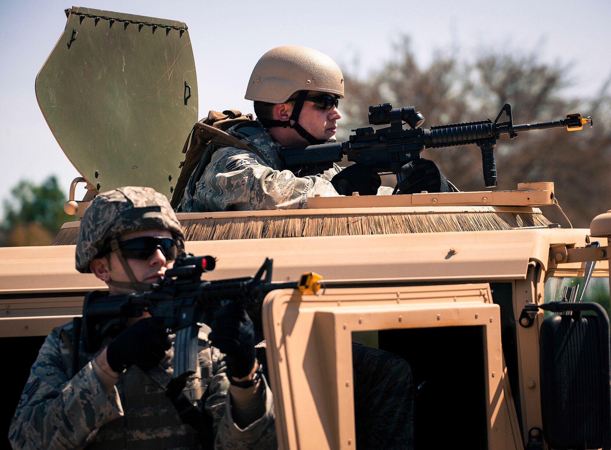 919th Security Forces Squadron Airmen guard the perimeter from a HMMWV during an extraction exercise at Duke Field, Fla., April 6. The Security Forces Airmen executed this training exercise with the trainees from the Development and Training Program. The DTP is an Air Force Reserve Command introductory program to help recruits prepare for military life prior to going to basic military training. The trainees were given a first-hand view of the procedures performed to recover American personnel from a downed aircraft in a hostile environment. (U.S. Air Force photo/Tech. Sgt. Samuel King Jr.)