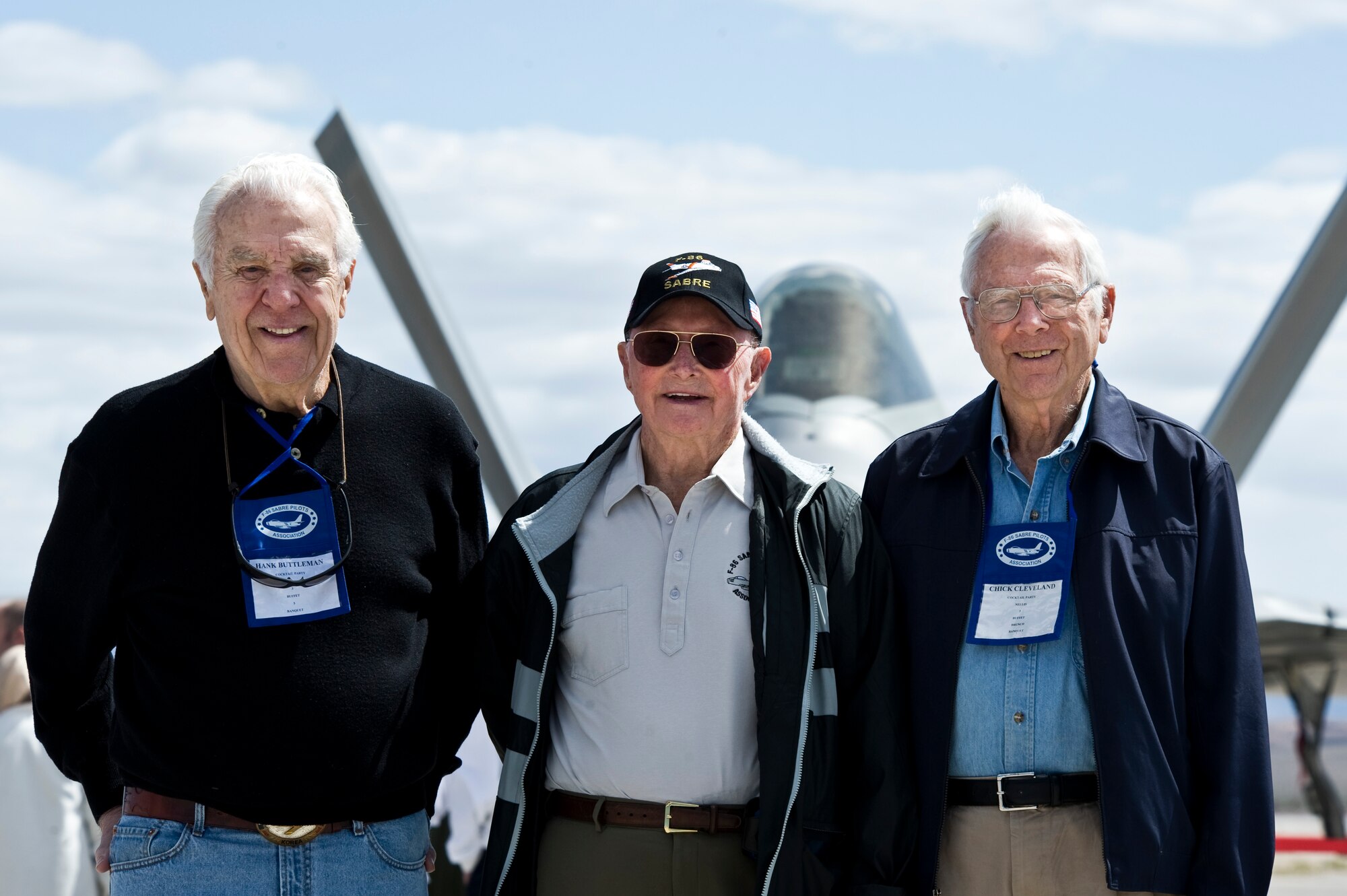 (From left to right) Hank Buttleman, Cecil G. Foster, and Chick Cleveland, retired Air Force Korean War flying aces, pose in front of an F-22 Raptor April 9, 2013, during a Sabre Society tour at Nellis Air Force Base, Nev.  A flying ace is a military aviator credited with shooting down several enemy aircraft during aerial combat. Buttleman has seven victories, Foster has nine, and Cleveland has five. The actual number of aerial victories required to officially qualify as an ace has varied, but is usually considered to be five or more. (U.S. Air Force Photo by Airman 1st Class Jason Couillard) 