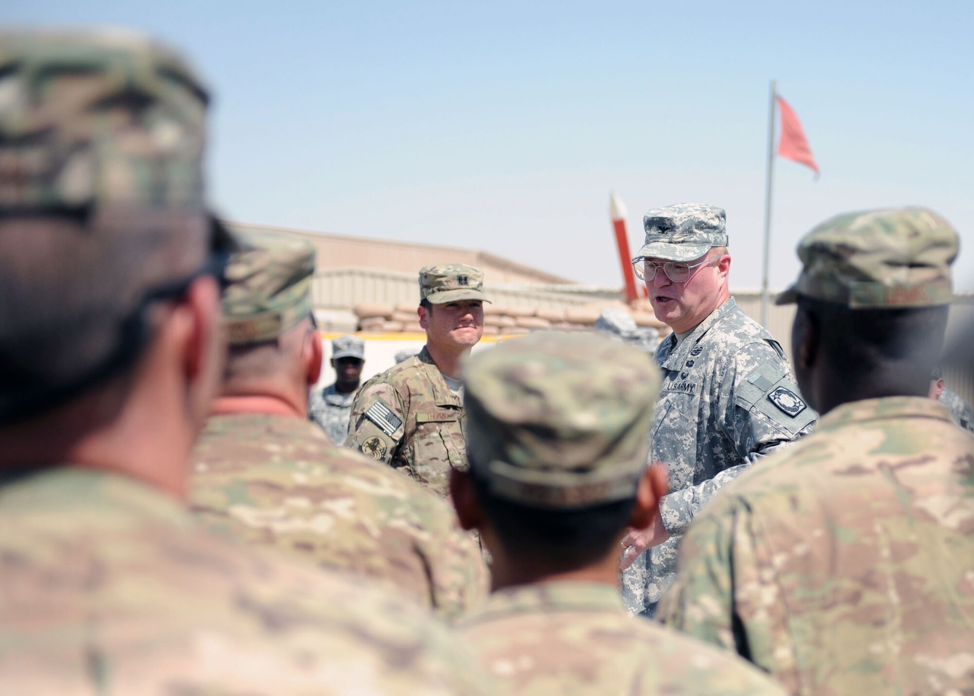 SOUTHWEST ASIA -  Army Col. Randall McIntire, 69th Air Defense Artillery Brigade commander, thanks 18 Airmen assigned to the 557th Expeditionary Red Horse Squadron and 577th Expeditionary Prime Beef Squadron for their support of the 1-43 Air Defense Auxiliary Battalion after awarding them an Army Commendation or Achievement Medal, April 9. (U.S. Army photo/Capt. Steven Modugno)