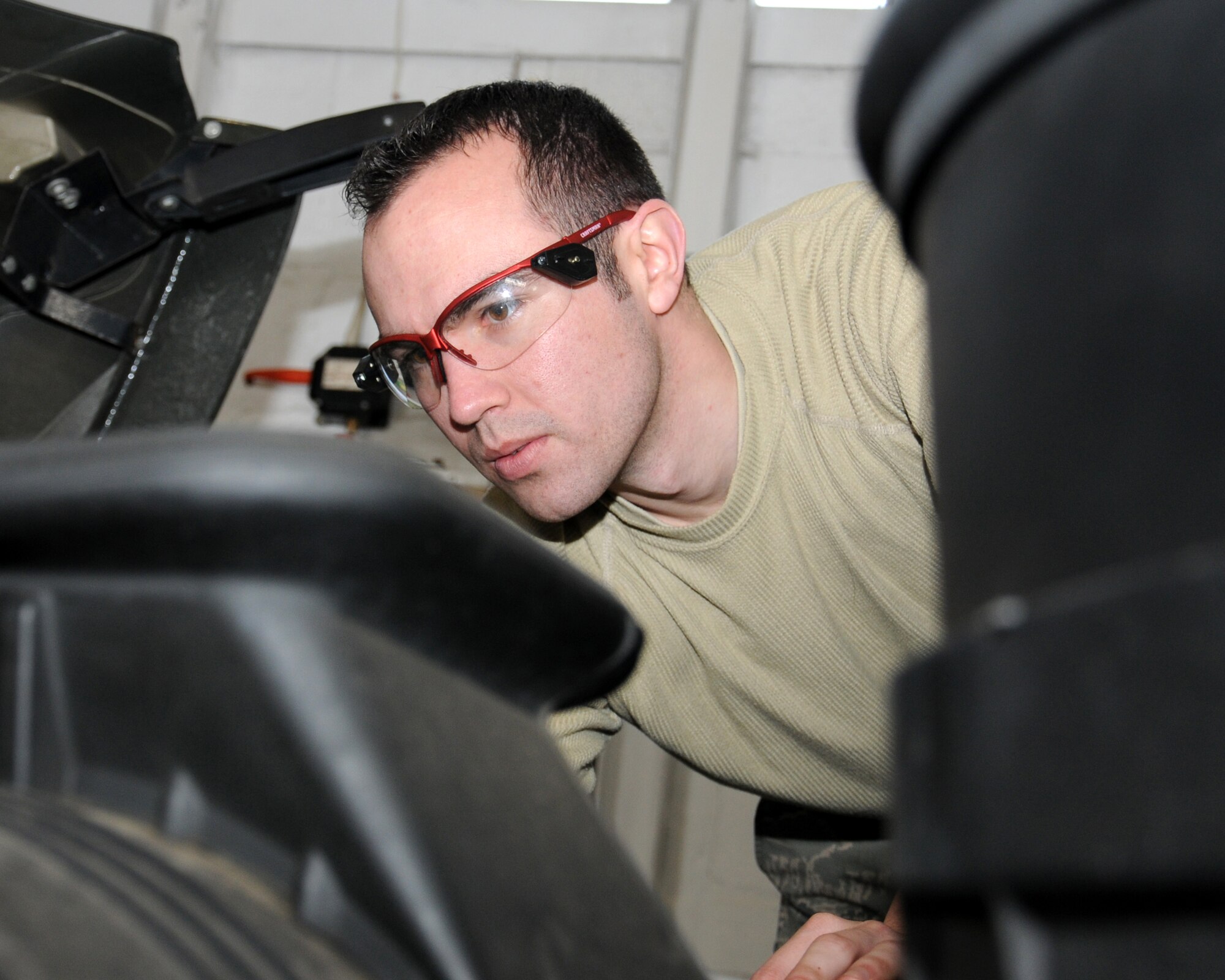 Staff Sgt. Tyler Barresi, 100th Logistics Readiness Squadron vehicle maintenance journeyman from Gaylord, Mich., adjusts a belt tensioner on a refueling truck April 10, 2013, at RAF Mildenhall, England. This kind of adjustment helps ensure all the components are working correctly. The trucks must be ready for use at all times so fuel can be transported to, and pumped into, the planes. (U.S. Air Force photo by Gina Randall/Released)