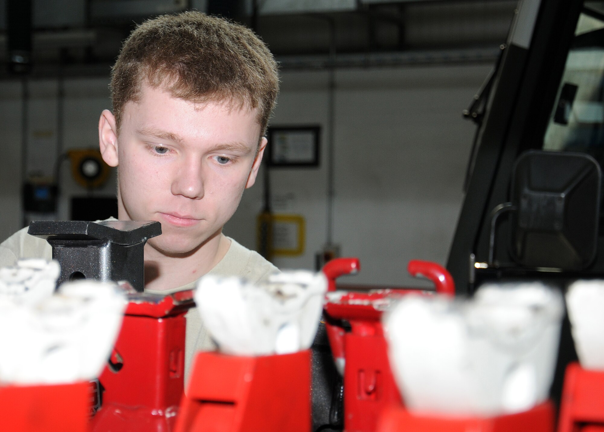 Airman 1st Class Jacob Ward, 100th Logistics Readiness Squadron special purpose vehicle maintenance apprentice from Roseburg, Ore., checks jack stands serviceability April 10, 2013, at RAF Mildenhall, England. The jacks are used to change tires as well as raise a vehicle so the mechanics can work on its suspension. (U.S. Air Force photo by Gina Randall/Released)