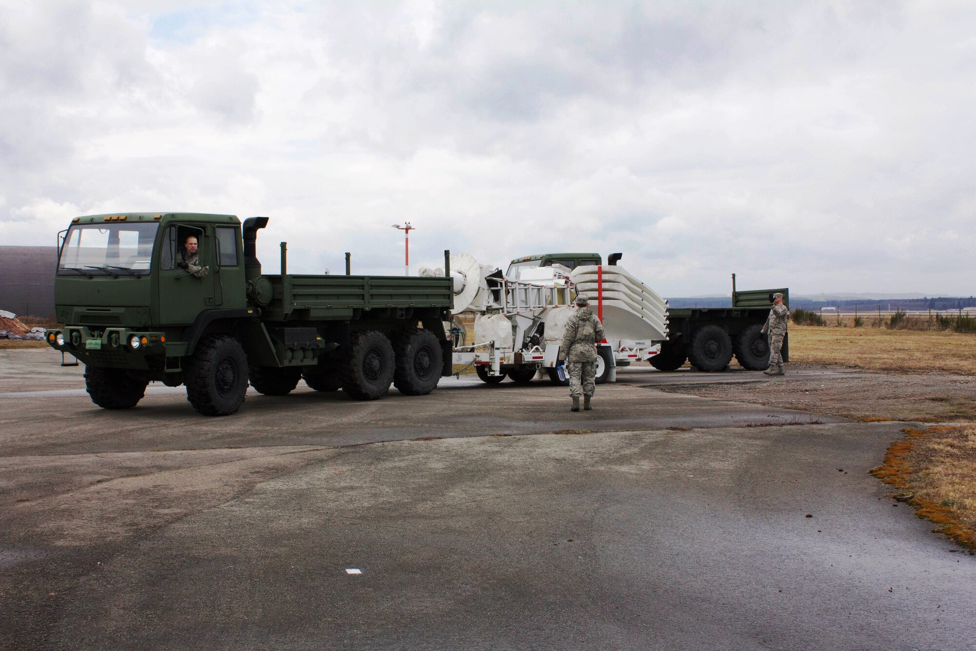 Eagle Vision One members, Master Sgt. Brian Frutiger (driver), Tech. Sgt. Stephen Parsons (middle) and Staff Sgt. Michael Kwain (right), transport the commercial imagery downlink system to the 435th Construction Training Squadron field training compound during a mock deployment April 10, 2013. As part of the 24th Intelligence Squadron, Eagle Vision One provides timely, flexible and tailored broad-area commercial satelite imagery products and services in support of combatant commander requirements. (U.S. Air Force photo / Staff Sgt. Joseph Morley)