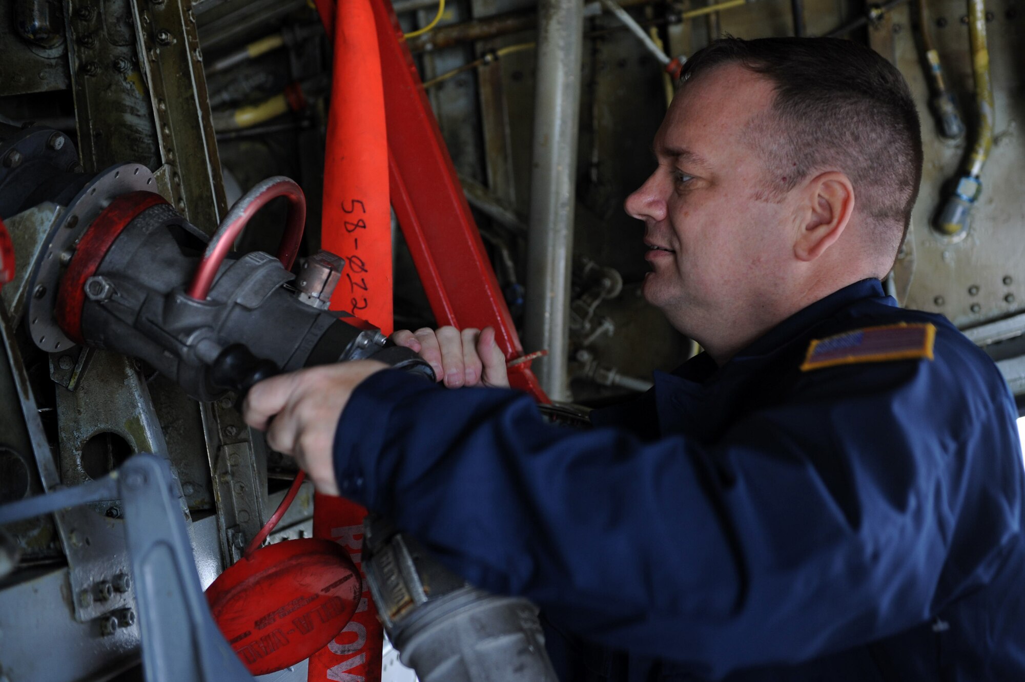 U.S. Air Force Col. Brian McDaniel, 18th Wing vice commander, places a refueling hose into the single- point refueling receptacle of a KC-135 Stratotanker on Kadena Air Base, Japan, April 11, 2013. Airmen from the 909th AMU taught McDaniel how aircraft maintenance is accomplished. (U.S. Air Force photo by Airman 1st Class Hailey R. Davis)