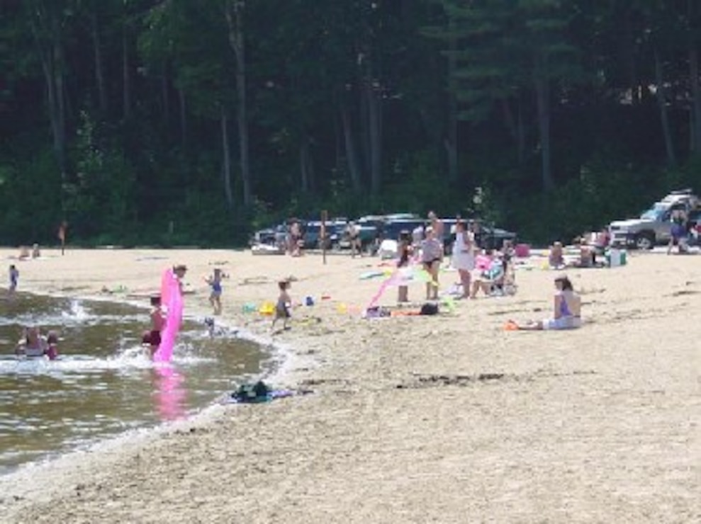 Families enjoying the beach at Townshend Lake, Townshend, Vt., is nestled in the foothills of the Green Mountains and offers lots of outdoor recreation fun. Families come to enjoy the extensive shaded picnic areas overlooking the swimming and play areas. Picnic tables, grills, horseshoe pits, volleyball set-ups, grassy play areas, and two modern restrooms are provided for the enjoyment of our visitors.