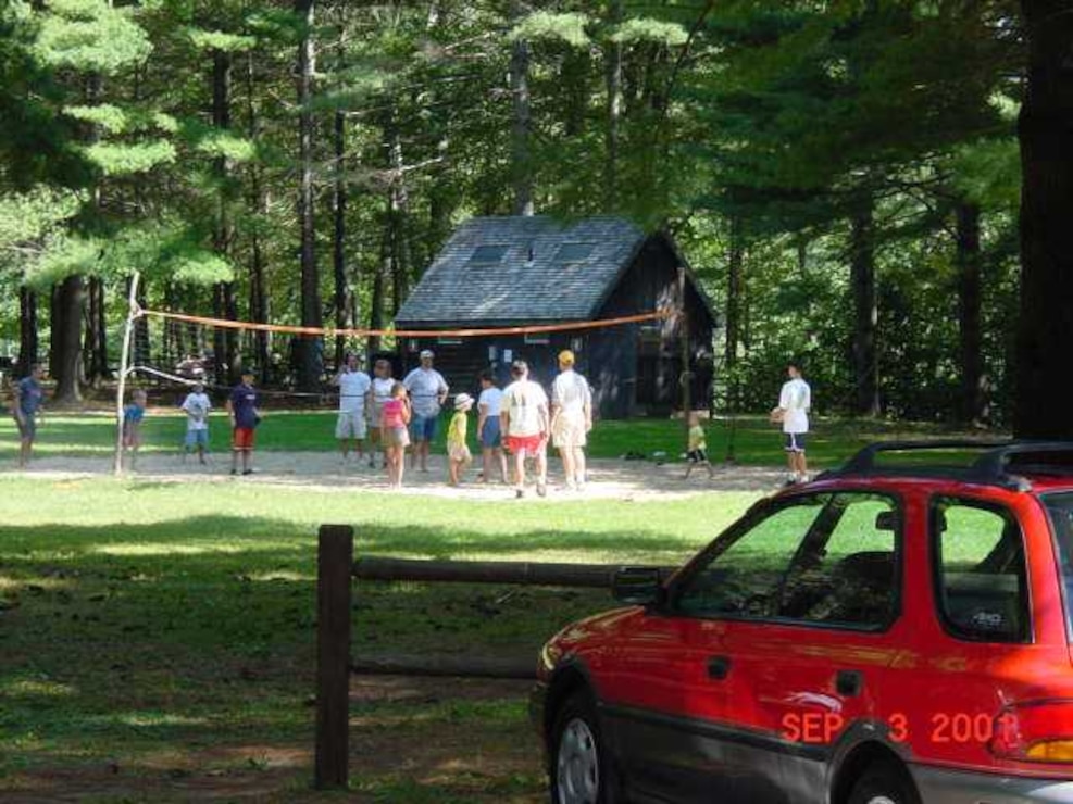 Playing volleyball at Townshend Lake, Townshend, Vt. Families come to enjoy the extensive shaded picnic areas overlooking the swimming and play areas. Picnic tables, grills, horseshoe pits, volleyball set-ups, grassy play areas, and two modern restrooms are provided for the enjoyment of our visitors.