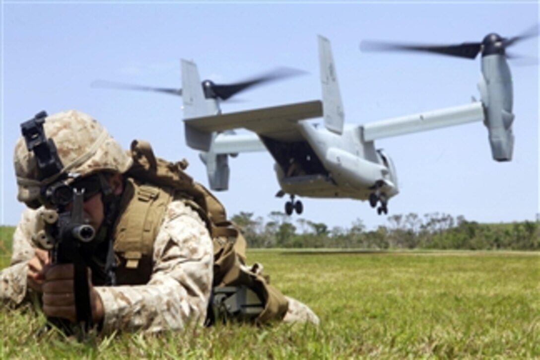 U.S. Marine Corps Lance Cpl. Andrew R. Becker provides landing zone security as an MV-22B Osprey touches down during training at the central training area in Okinawa, Japan, on April 11, 2013.  Becker is a combat engineer with Combat Assault Battalion, 3rd Marine Division, III Marine Expeditionary Force.  The Osprey is attached to Marine Medium Tiltrotor Squadron 265.  