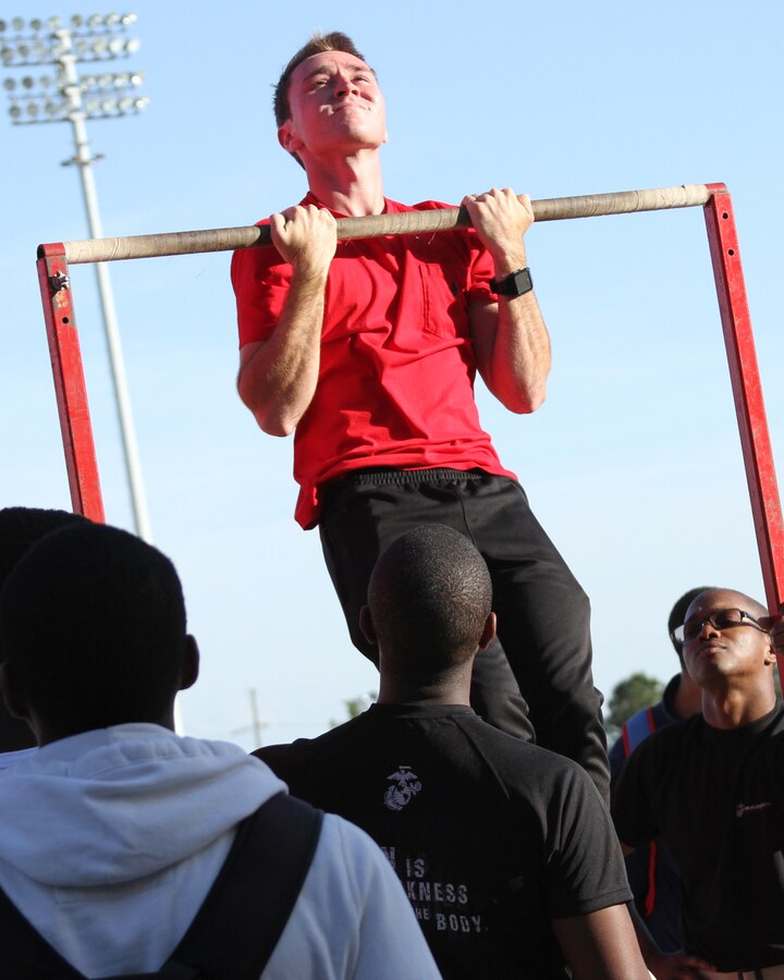 A spectator participates in the Chin-Up Challenge during the Taco Bell Track & Field Classic on April 13 at Spring Valley High School in Columbia, S.C. The Marines participated in the event for a third year to promote the Marine Corps. (Marine Corps Photo by Sgt. Aaron Rooks)