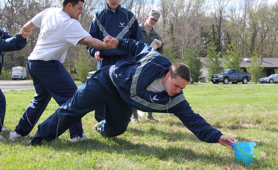 Senior Airman Joel Clements leans in to grab the bucket of water during team building exercises that challenged 932nd Maintenance Group members in a variety of skills and tasks.  (U.S. Air Force photo/Tech. Dan Oliver)