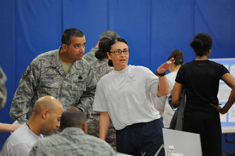 Capt. Tisha Cornett, 386th Expeditionary Medical Group, provides information to Master Sgt. Michael Lucena during the 386th Air Expeditionary Wing wellness fair Apr 13, 2013. Cornett organized the fair around Air Mobility Command’s Comprehensive Airman Fitness model. (U.S. Air Force photo by Senior Master Sgt. George Thompson)