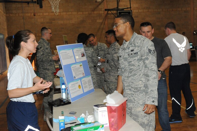 Senior Airman Katrina Wasche, 386th Expeditionary Medical Group, prepares to test Senior Airman Reginald Jackson’s blood glucose level during the 386th Air Expeditionary Wing wellness fair Apr 13, 2013. The wellness fair was represented by more than 20 wing agencies which provided information and resources to the service members and civilians assigned to ‘The Rock’. (U.S. Air Force photo by Senior Master Sgt. George Thompson)