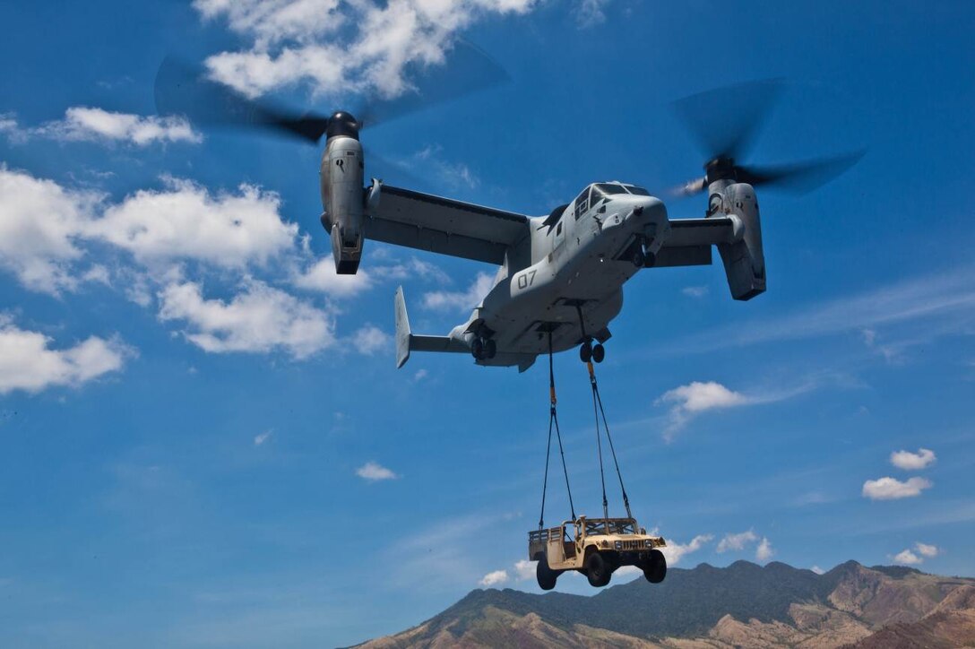 SUBIC BAY, Philippines – An MV-22B Osprey lifts a high mobility multipurpose wheeled vehicle from the USNS Sacagawea April 11 at Subic Bay, Republic of the Philippines, during exercise Freedom Banner 2013. The aircraft is with Marine Medium Tiltrotor Squadron 265, Marine Aircraft Group 36, 1st Marine Aircraft Wing. (U.S. Marine Corps photo by Pfc. Kasey Peacock/Released)