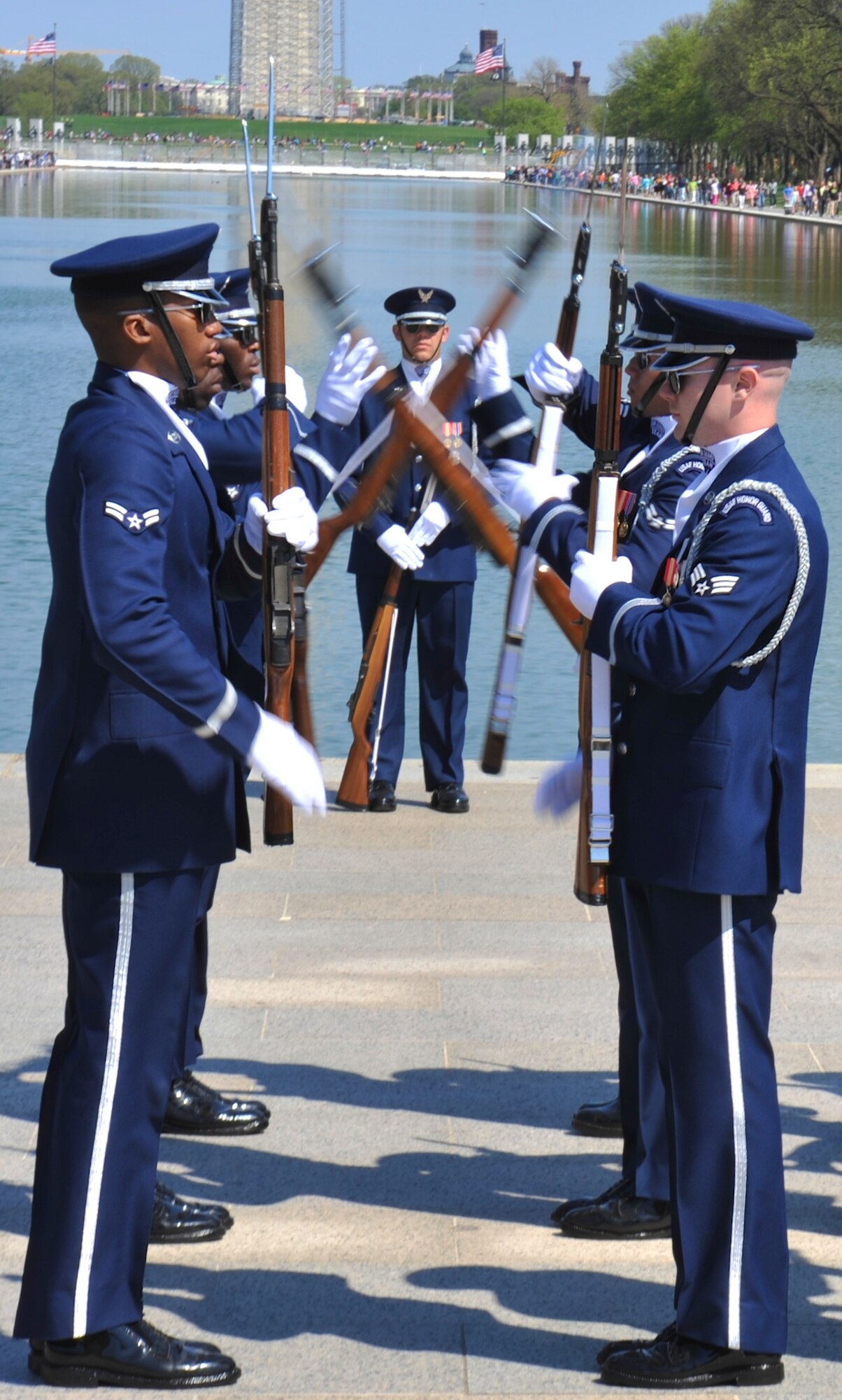 Members of the U.S. Air Force Honor Guard Drill Team exchange their M-1 Garand rifles by tossing them to each other April 13, 2013, at the National Cherry Blossom Festival in Washington, D.C. The Drill Team promotes the Air Force mission by showcasing highly perfected drill performances at public and military venues to recruit, retain, and inspire fellow Airmen. (U.S. Air Force photo/Airman 1st Class Alexander W. Riedel)