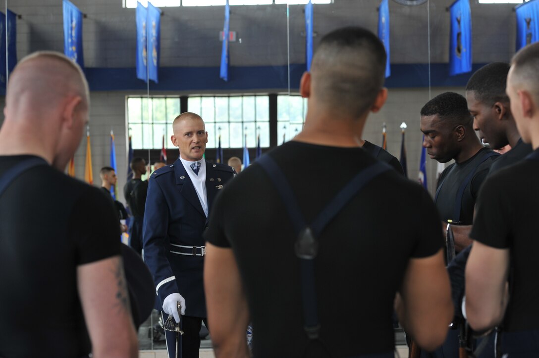 First Lt. Michael Lemorie stomps his saber on the ground as he speaks to Airmen with the U.S. Air Force Honor Guard's Drill Team, April 13, 2013 at Joint Base Anacostia-Bolling, Washington, D.C. Lemorie is the Drill Team flight commander, and told his Team of his confidence in their success at the Joint Service Drill Exhibition at the National Cherry Blossom Festival. (U.S. Air Force photo/Airman 1st Class Alexander W. Riedel)
