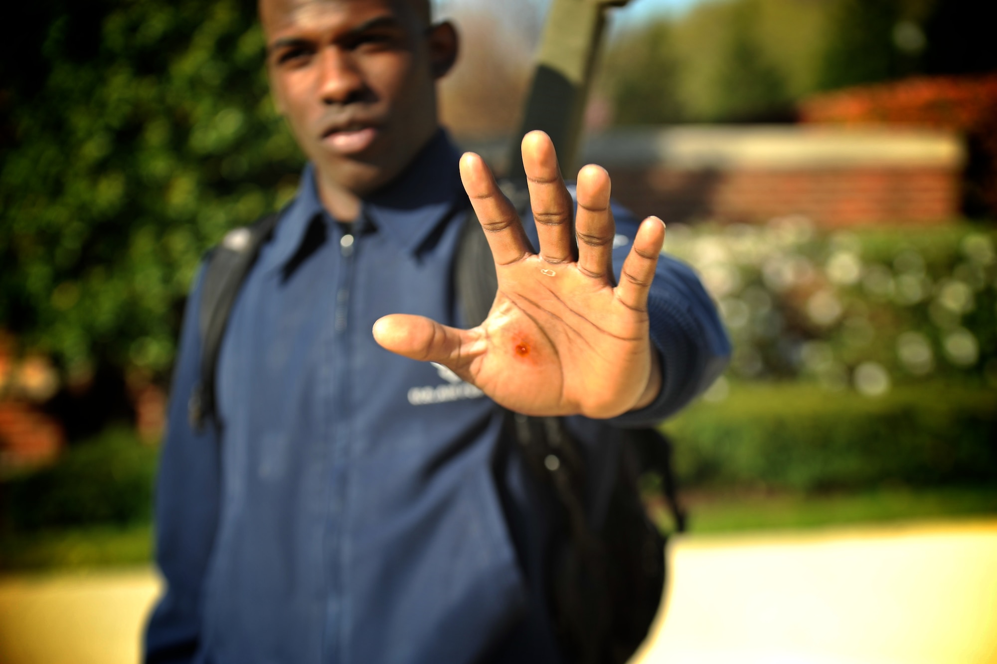 Senior Airmen Billy Degraffenreid shows the cut to his hands he incurred while performing in a U.S. Air Force Honor Guard Drill Team performance April 13, 2013, at the National Mall, Washington, D.C. Degraffenreid is a senior member of the Drill Team and mangaged to a catch an incorrectly tossed M-1 Garand rifle at the bayonet, successfully completing the drill in front of a cheering audience at the National Cherry Blossom Festival. (U.S. Air Force photo/Airman 1st Class Alexander W. Riedel)