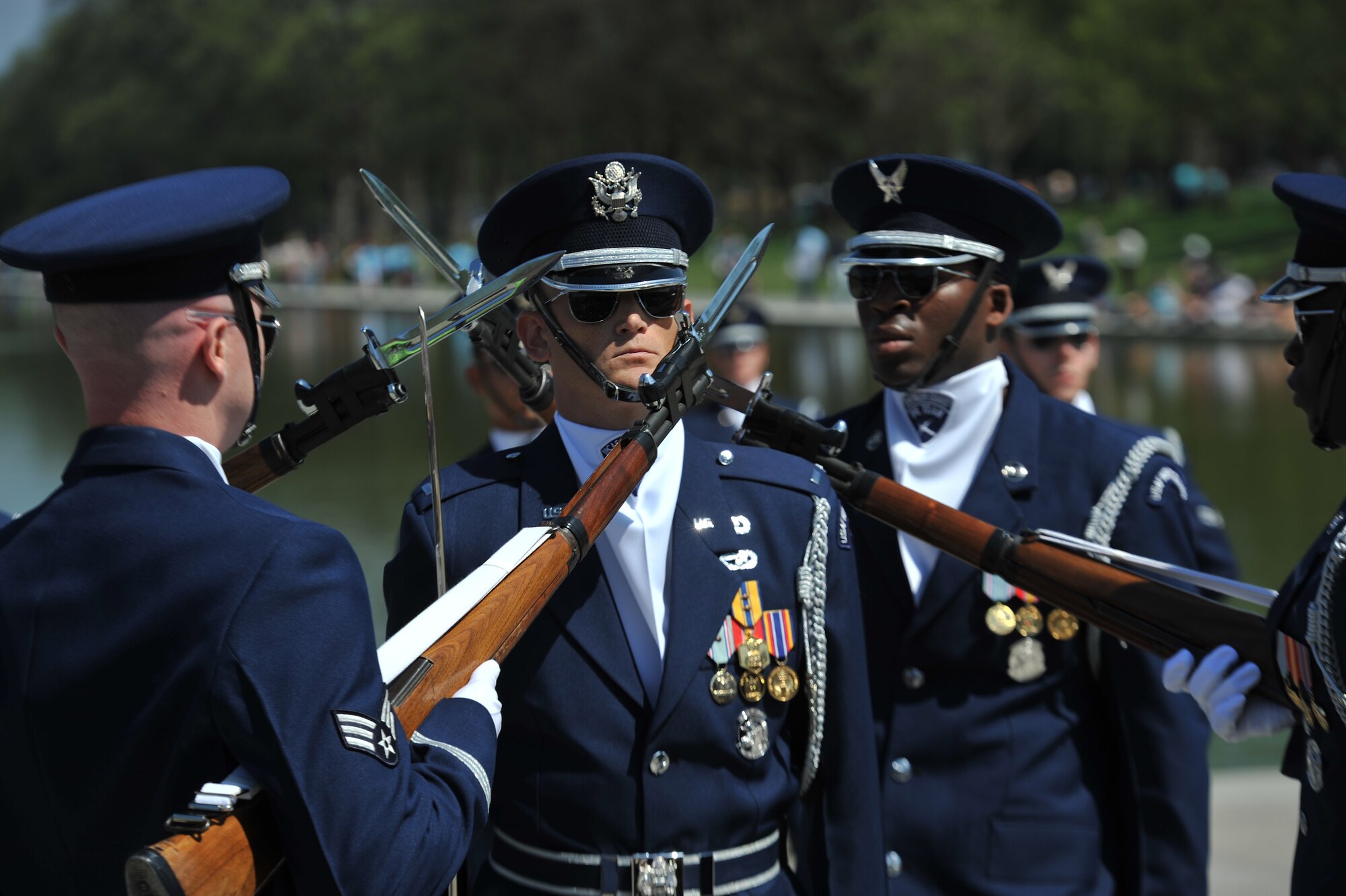 First Lt. Michael Lemorie is surrounded by the bayonets of fellow U.S. Air Force Honor Guard Drill Team members April 13, 2013, at the National Cherry Blossom Festival in Washington, D.C. As the Drill Team's flight commander, Lemorie often places himself in the middle of dangerous group movements and rifle exchanges to represent the trust Air Force officer have in the Airmen they lead. (U.S. Air Force photo/Airman 1st Class Alexander Riedel)