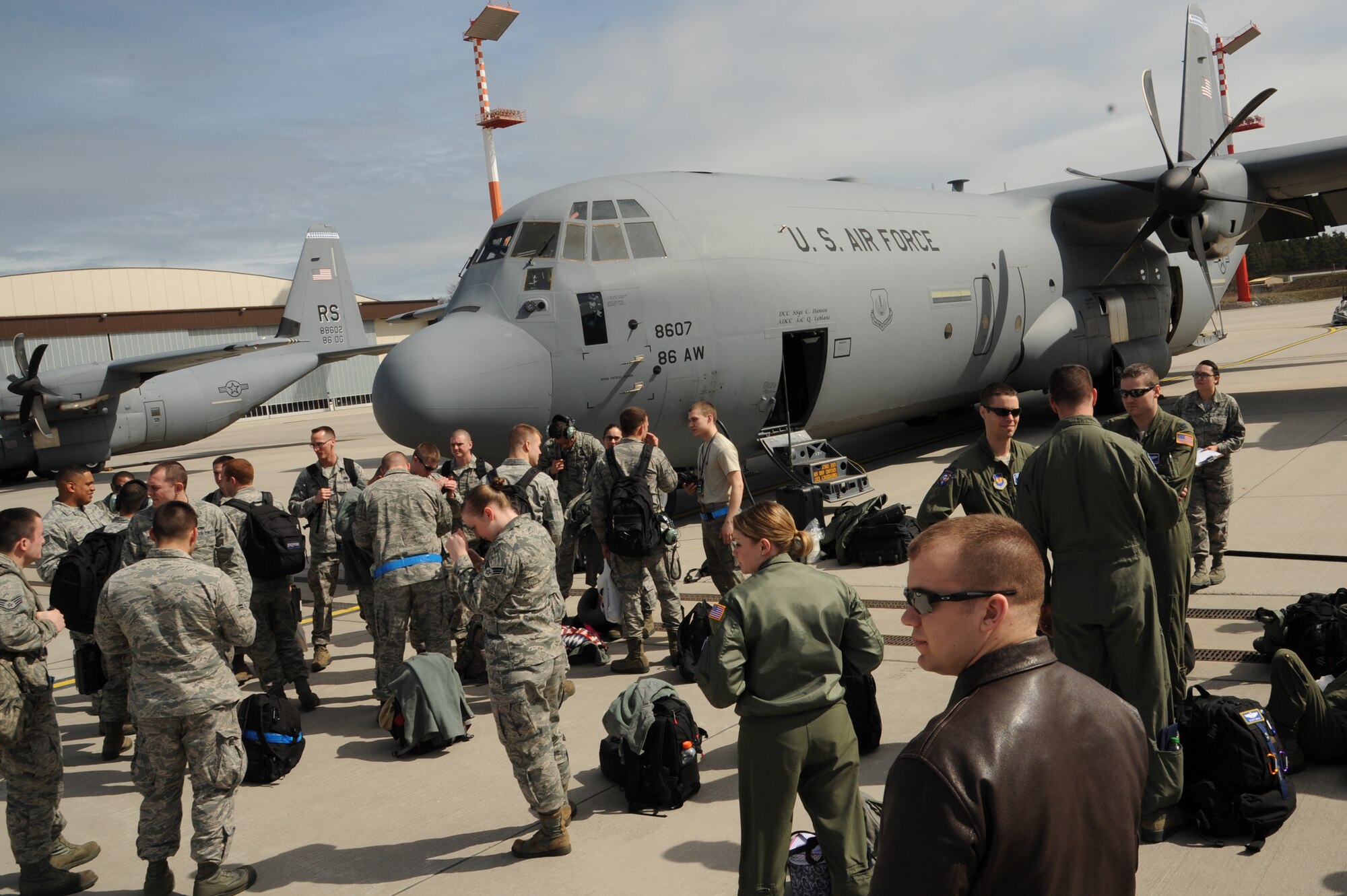 Airmen prepare to board a C-130J Super Hercules for Exercise Carpathian Spring located in Romania, April 14, 2013, Ramstein Air Base, Germany. The exercise runs through April 21 and is designed for aircrews to train as well as help build a partnership capacity with Romanians. (U.S. Air Force photo/Airman 1st Class Hailey Haux)
