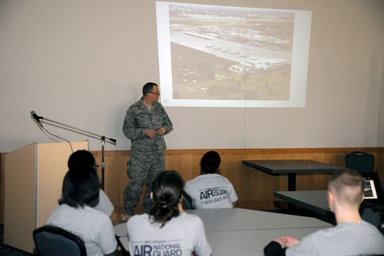 Technical Sgt. Dan Heaton, 127th Public Affairs photojournalist, shows an overview photograph of Selfridge Air National Guard Base to members of the wing's Student Flight during a historical presentation on the base's namesake, Lt. Thomas E. Selfridge, and the first commander of the base in 1917, Capt. Byron Q. Jones, on April 13, 2013.  The current airfield was compared to the muddy grass field from nearly 100 years ago, when the airplanes flown first had to be assembled by their pilots and maintainers, Heaton explained.  (Air National Guard photo by TSgt. David Kujawa)