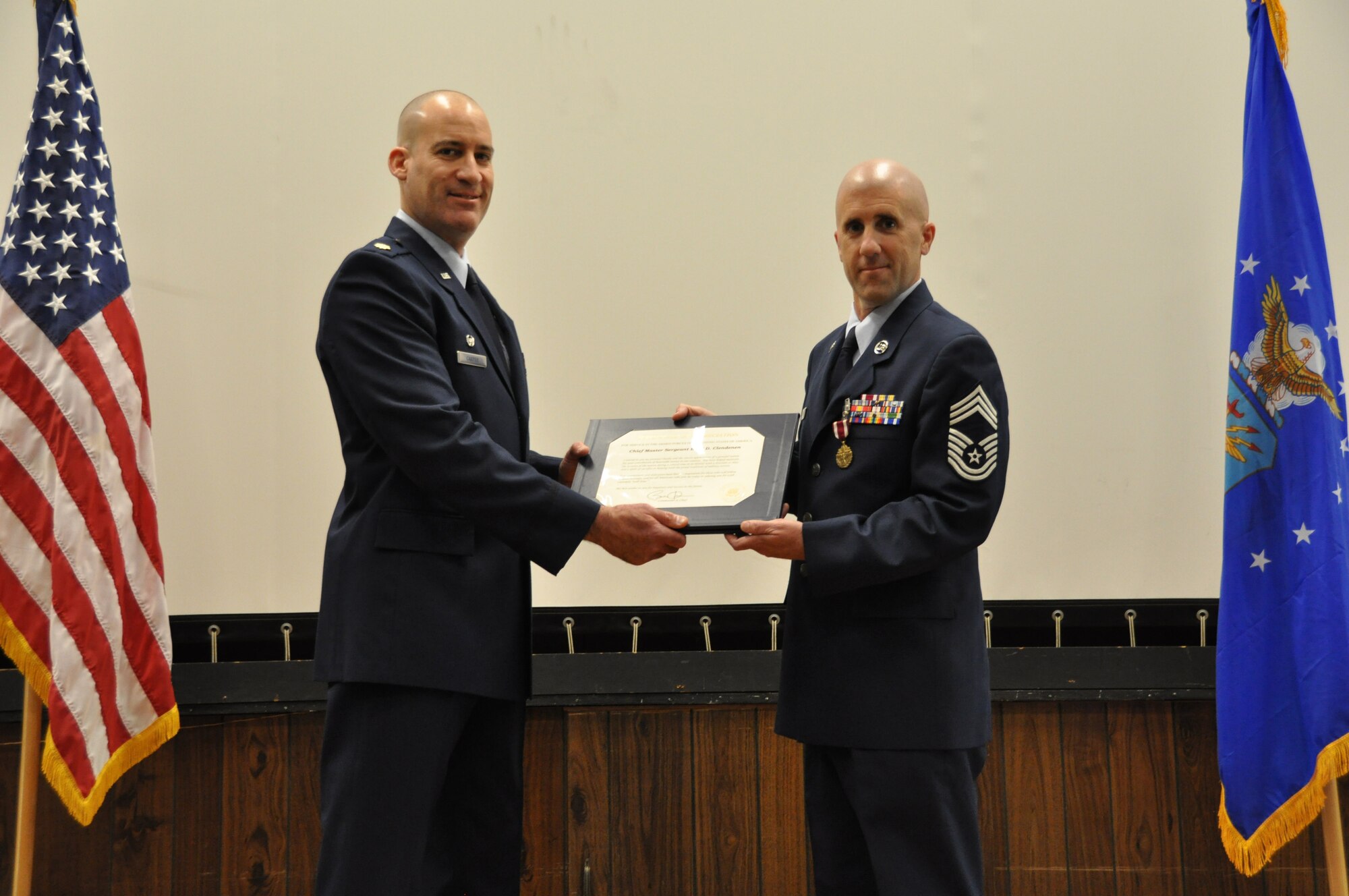 Major Bruce Carper (left), 69th Aerial Port Squadron commander, passes a letter of appreciation from President Barack Obama to Chief Master Sgt. Boyd Clendenen, 69 APS chief of combat readiness and training, during a retirement ceremony here Apr. 13, 2013. Chief Clendenen is retiring from the 459th Air Refueling Wing after 23 years in the U.S. Air Force, culminating nearly 30 years in the armed forces. Clendenen plans to continue working with Lockhead Martin, enjoy more time with his family and explore his options for beginning a new career. (U.S. Air Force photo/Staff Sgt. Amber Russell)
