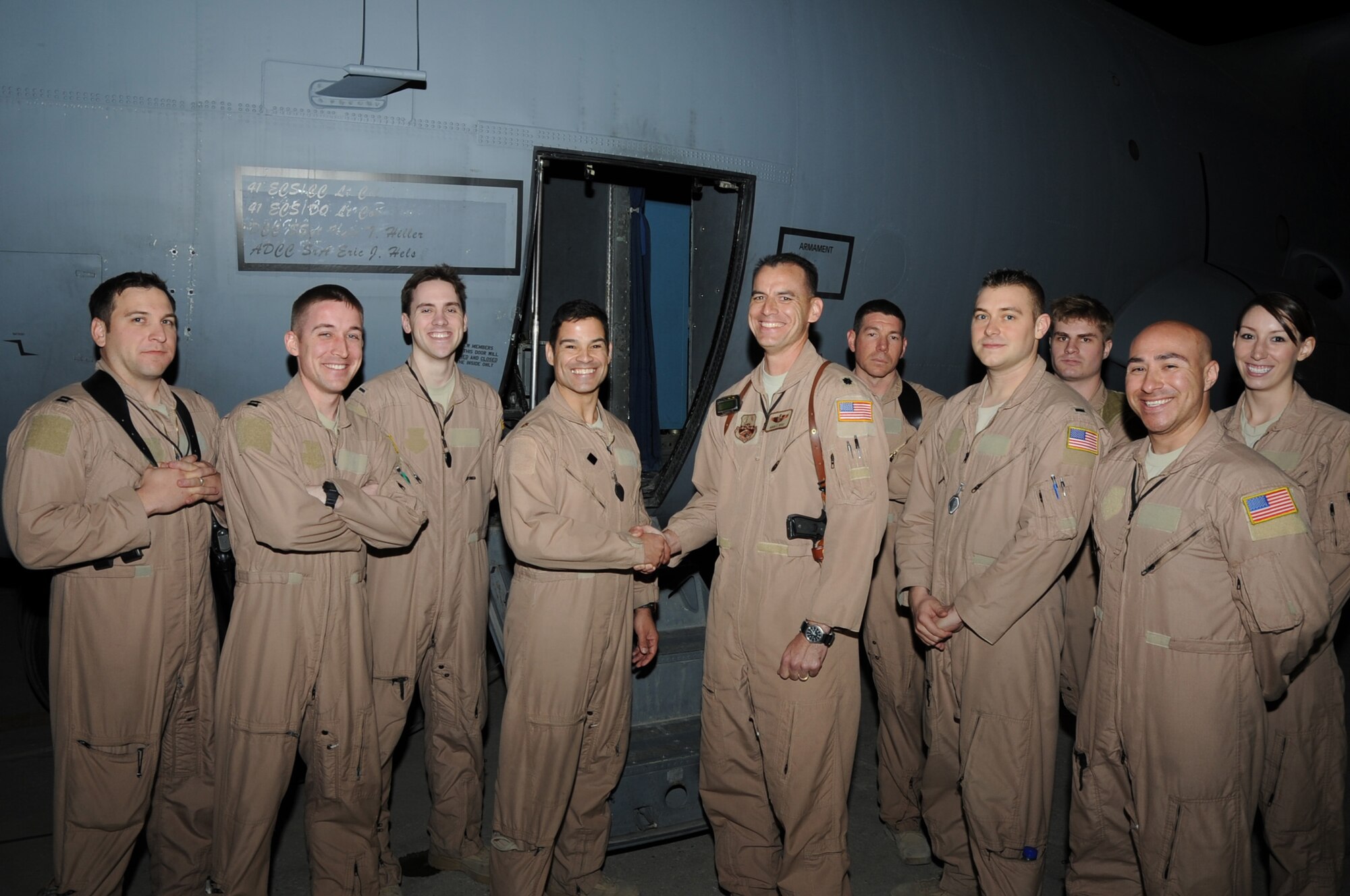 Lt. Col. Arvid Opry, 41st Expeditionary Electronic Combat Squadron commander, congratulates Maj. David Gonzalez, 41st EECS pilot, and his crew on the flightline on Bagram Airfield, Afghanistan, April 14, 2013. Gonzalez's crew flew the mission that gave the 41st EECS its 30,000 combat flight hour in Afghanistan. (U.S. Air Force photo/Staff Sgt. David Dobrydney)