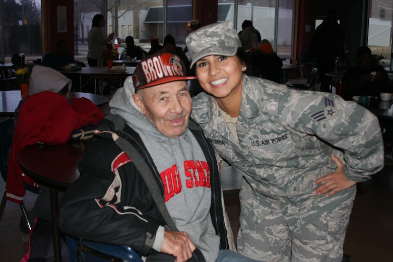 Senior Airman Chelsea Menchaca poses with one of Toledo’s many less
fourunate at the Cherry Street Mission, Toledo, Ohio as part of a community
outreach project with the 180th Fighter Wing’s Logistics Readiness
Squadron in February. (Courtesy Photo/Released).