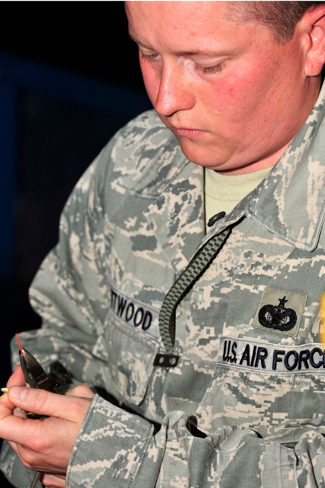 U.S. Air Force Staff Sgt. Gary Chitwood, 380th Expeditionary Security Forces Squadron Tactical Automated Security System (TASS) administrator, splices fiber optic wire used in TASS at an undisclosed location in Southwest Asia Mar. 20, 2013. Fiber optic wire allows the system's hardware to communicate with the software which allows security forces members to secure the installation a more effectively. (U.S. Air Force photo by Tech. Sgt. Christina M. Styer/Released)  