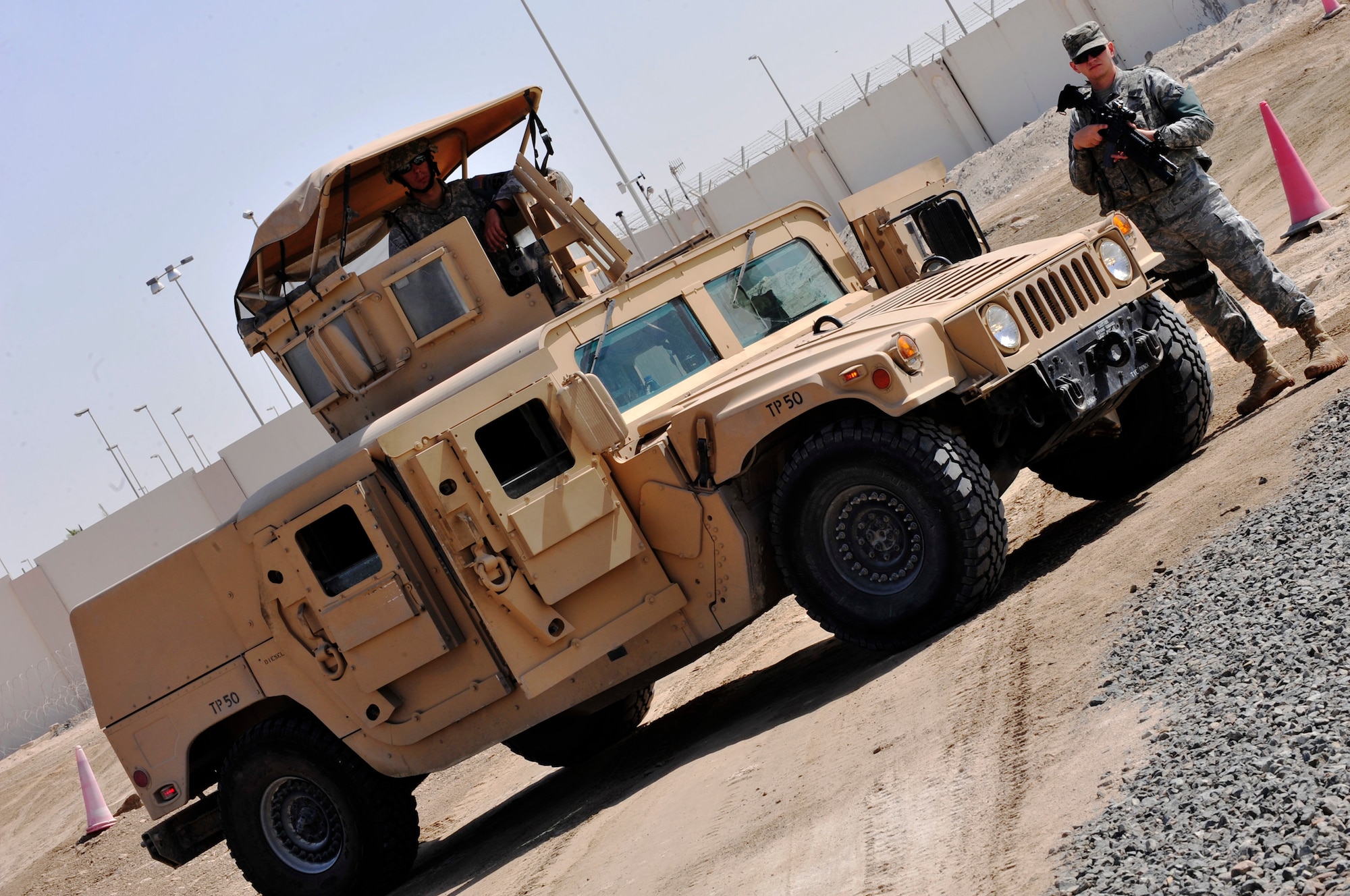 Members of the 380th Expeditionary Security Forces Squadron Quick Response Force provide overwatch during a demonstration of the Tactical Automated Security System (TASS) at an undisclosed location in Southwest Asia Mar. 20, 2013. TASS is a collection of equipment, using different technologies, designed to secure multiple perimeters. (U.S. Air Force photo by Tech. Sgt. Christina M. Styer/Released)  