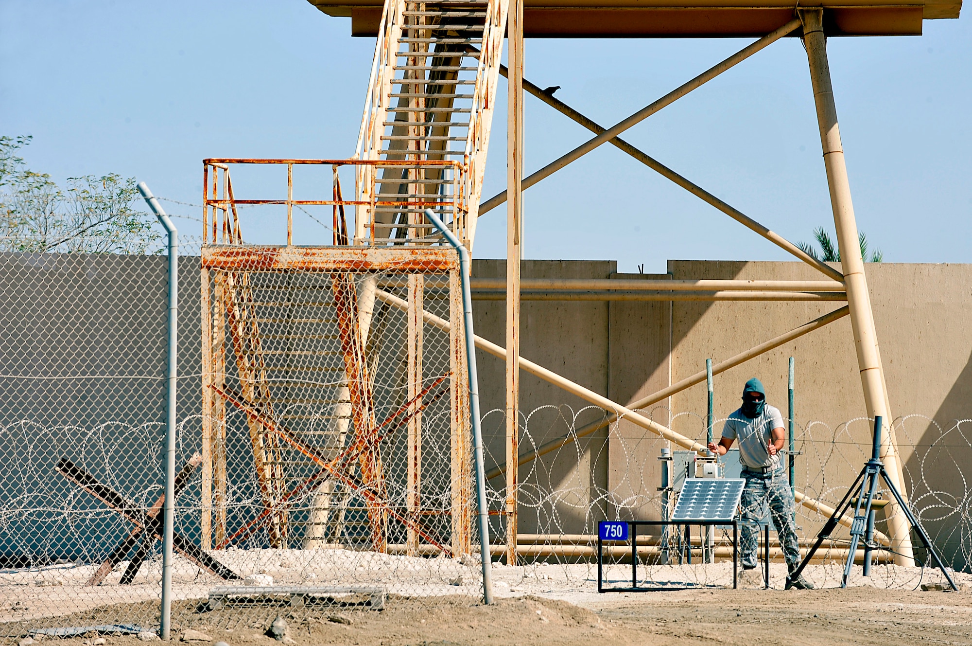 U.S. Air Force Airman 1st Class William Densford, 380th Expeditionary Security Forces Squadron random access measures team member, plays an intruder attempting to infiltrate the installation during a demonstration of the Tactical Automated Security System (TASS) at an undisclosed location in Southwest Asia Mar. 20, 2013. TASS is a collection of equipment, using different technologies, designed to secure multiple perimeters. (U.S. Air Force photo by Tech. Sgt. Christina M. Styer/Released)  