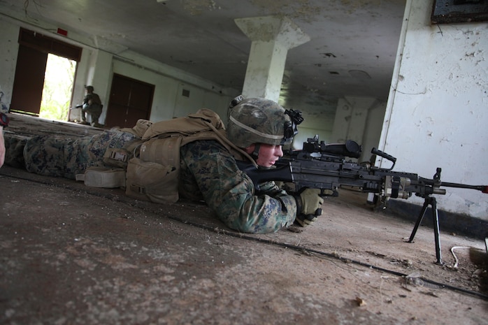 Lance Cpl. Dylan M. Czoka sights in on the enemy with his M-240 Bravo machine gun April 10 during final field exercises on Andersen South during Exercise Guahan Shield.  The exercises consisted mainly of raids and patrols in and around abandoned housing areas and the surrounding jungle in which logistics Marines acted as insurgents against Infantrymen.  Guahan Shield will facilitate multiservice engagements, set conditions for bilateral and multilateral training opportunities, and support rapid response to potential theatre crises and contingency operations in the Asia-Pacific region.  The logistics Marines are part of Combat Logistics Detachment 39, 9th Engineer Support Battalion, 3rd Marine Logistics Group, III Marine Expeditionary Force.  Czoka is a Rifleman with Company L, 3rd Battalion, 6th Marine Regiment, which is currently assigned to 4th Marine Regiment, 3rd Marine Division, III Marine Expeditionary Force under the unit deployment program. 