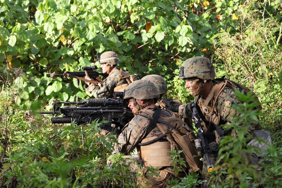 Staff Sgt. Owen I. Wood leads his Marines in a raid April 8 during final field exercises on Andersen South during Exercise Guahan Shield.  The exercises consisted mainly of raids and patrols in and around abandoned housing areas and the surrounding jungle, in which logistics Marines went toe-to-toe with Infantrymen.  Guahan Shield will facilitate multiservice engagements, set conditions for bilateral and multilateral training opportunities, and support rapid response to potential theatre crises and contingency operations in the Asia-Pacific region.  The logistics Marines are part of Combat Logistics Detachment 39, 9th Engineer Support Battalion, 3rd Marine Logistics Group, III Marine Expeditionary Force.  Wood is a Platoon Sgt. with Company L, 3rd Battalion, 6th Marine Regiment, which is currently assigned to 4th Marine Regiment, 3rd Marine Division, III MEF under the unit deployment program.  