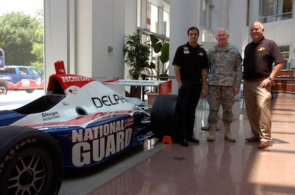 Driver Vitor Meira, Maj. Gen. Ray Carpenter, special assistant to the director of the Army National Guard, and Panther Racing team owner John Barnes unveil the new 230-MPH, No. 4 National Guard IndyCar at the Army National Guard Readiness Center at Arlington Hall in Arlington, Va., on June 25, 2008. The National Guard is participating in the Indy Racing League for the first time.