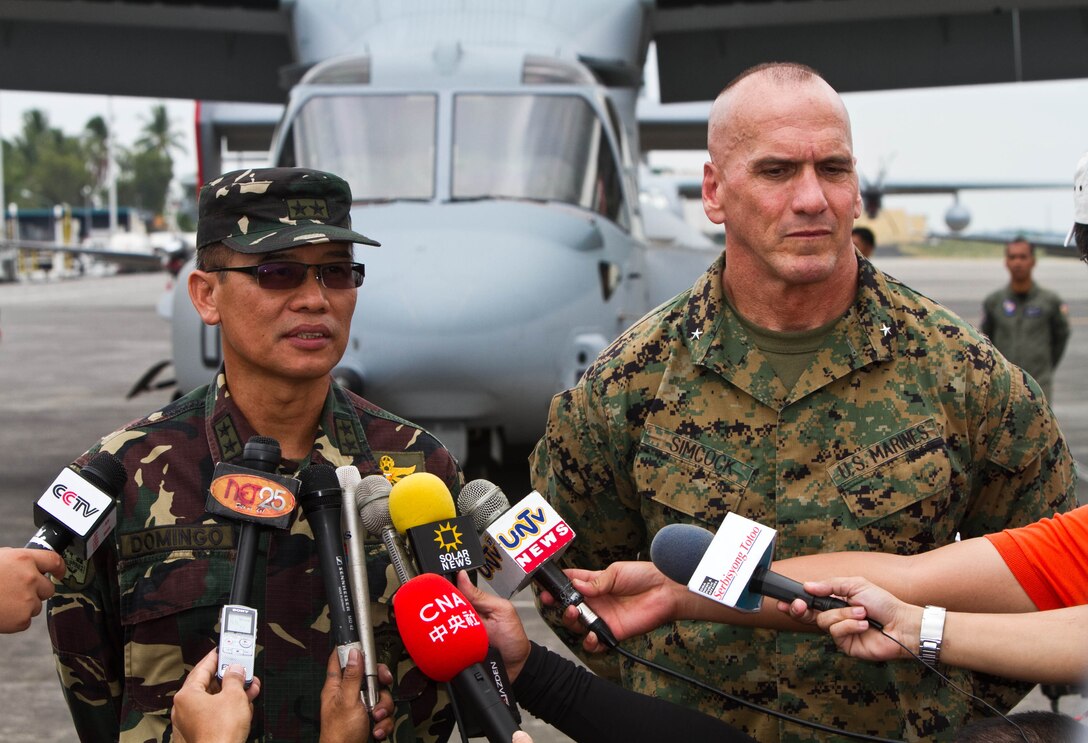 Philippine Army Maj. Gen. Virgilio Domingo, left, answers questions from the media shoulder-to-shoulder with U.S. Marine Brig. Gen. Richard L. Simcock, II, right, during a static display at Clark Field, Philippines, April 13 for exercise Balikatan 2013. BK13 is an annual bilateral training evolution aimed at ensuring interoperability of the Philippine and U.S. militaries during planning, contingency and humanitarian assistance operations. 