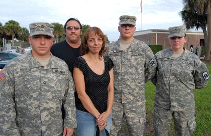 Richard and Patricia Hirsch of Fort Pierce, Fla., pose with their two sons and daughter-in-law, who are members of the Florida Army National Guard's 715th Military Police Company and are deploying together to Afghanistan this summer. Pictured are Pfc. Richard Hirsch (left), Richard Hirsch, Patricia Hirsch, Pfc. Joseph Hirsch and Pvt. Laura Hirsch. Joseph and Laura are married. The unit held a departure ceremony in Melbourne, Fla., July 3, 2008.