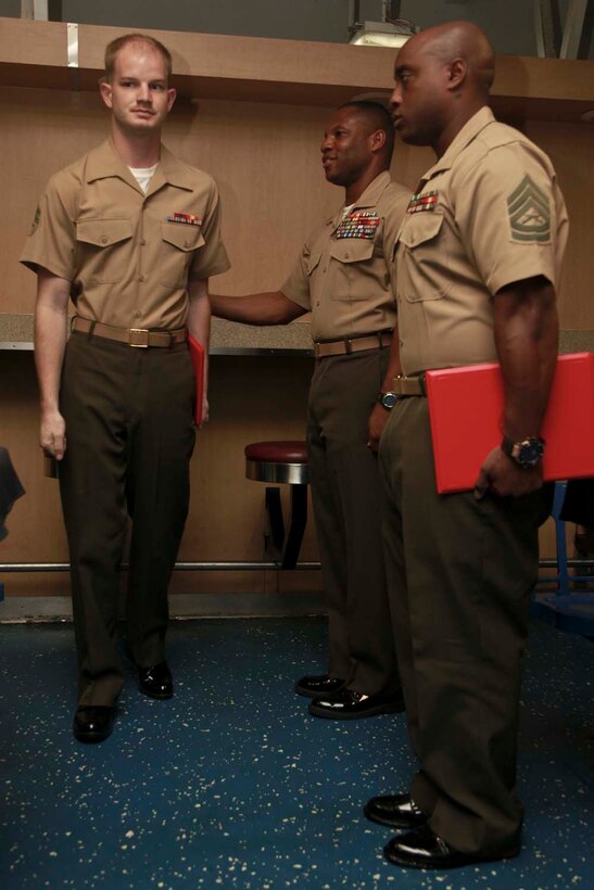 Corporal Jared S. Belew, aviation ordnance technician, Marine Medium Helicopter Squadron 364 (Rein.), 15th Marine Expeditionary Unit, marches off after receiving his Corporals' Course 338-13 certificate of completion from Sgt. Maj. John W. Scott, the 15th MEU sergeant major, on the mess decks of USS Peleliu, April 5. Corporals' Course is a professional military education for enlisted Marines designed to give corporals the tools to become more effective small unit leaders. The 15th MEU is comprised of approximately 2,400 Marines and sailors and is deployed as part of the Peleliu Amphibious Ready Group. Together, they provide a forward-deployed, flexible sea-based Marine Air Ground Task Force capable of conducting a wide variety of operations ranging from humanitarian aid to combat. Belew, 22, is from Lawrenceburg, Tenn. (U.S. Marine Corps photo by Cpl. John Robbart III/Released)