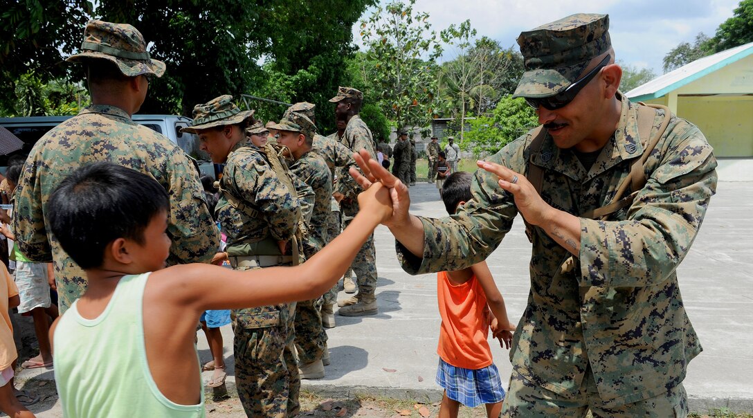 U.S. Marine Staff Sgt. Ruben Ramirez, a warehouseman with Combat Logistics Regiment 35, 3rd Marine Logistics Group, III Marine Expeditionary Force, playfully boxes with Kevin, a student at Maruglo Elementary School in Crow Valley, Philippines, April 12 during ongoing community relations events at Balikatan 2013, an annual Philippine-U.S. bilateral exercise. Humanitarian assistance and training activities enable the Philippine and U.S. forces to build lasting relationships, train together and provide assistance in communities where the need is the greatest.