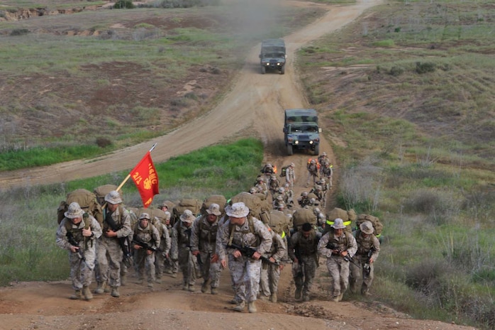 Marines serving with Fox Company, 2nd Battalion, 1st Marine Regiment, hike an 11-mile route with a full combat load to their next training destination here, April 2, 2013. The hike began at 6:30 a.m. and finished approximately four hours later. The company conducts hikes weekly to build strength, confidence and unit-readiness. Hikes also give small-unit leaders an opportunity to lead Marines and build camaraderie.