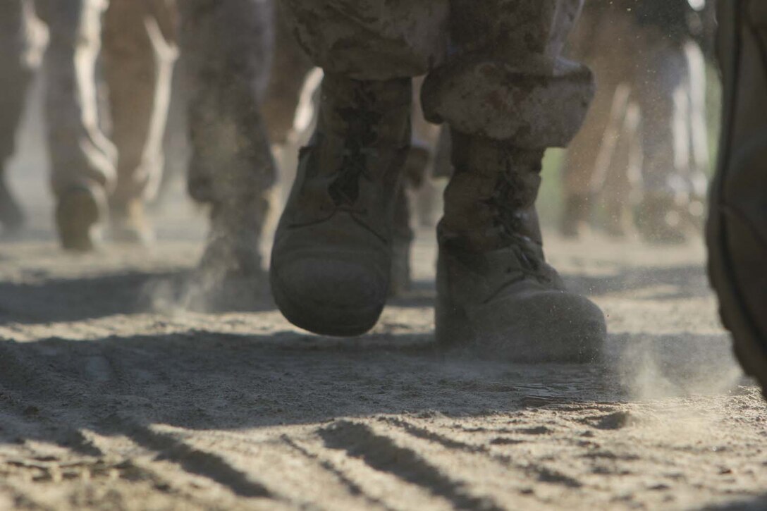 Marines serving with Fox Company, 2nd Battalion, 1st Marine Regiment, hike an 11-mile route with a full combat load to their next training destination here, April 2, 2013. The hike began at 6:30 a.m. and finished approximately four hours later. The company conducts hikes weekly to build strength, confidence and unit-readiness. Hikes also give small-unit leaders an opportunity to lead Marines and build camaraderie.