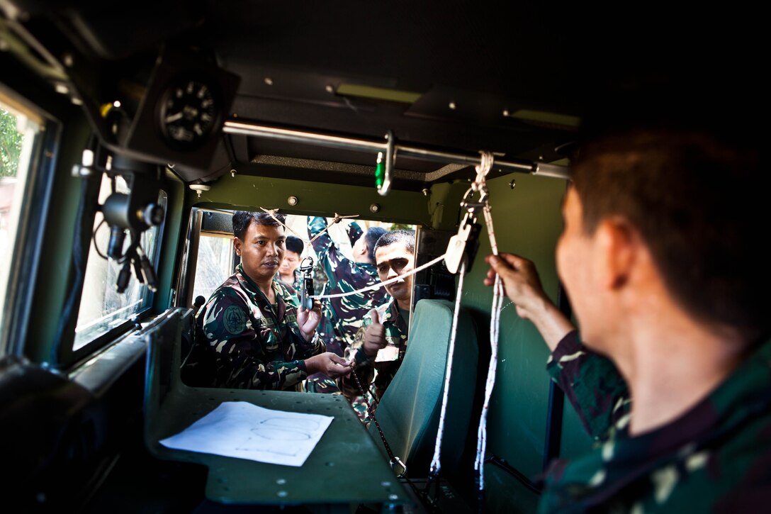 Explosive ordnance technicians with the Philippine Air Force utilize pieces of equipment from the Marine Corps hook and line system in a Humvee at Clark Field, Republic of the Philippines, April 10. Filipino and U.S. Marine Corps EOD technicians trained together during exercise Balikatan 2013, an annual bilateral exercise in its 29th iteration that is aimed at ensuring interoperability of the Philippine and U.S. militaries during planning, contingency and humanitarian assistance operations. (U.S. Marine Corps photo by Pfc. Kasey Peacock/Released)
