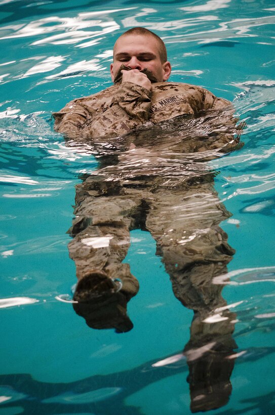 Cpl. Gernard Rathbun, 22nd Marine Expeditionary Unit armorer, treads water in the training pool at Marine Corps Base Camp Lejeune, N.C., for annual swim qualification April 5, 2013.  The unit is constantly training to maintain a high state of readiness. (Marine Corps photo by Sgt. Austin Hazard/Released)