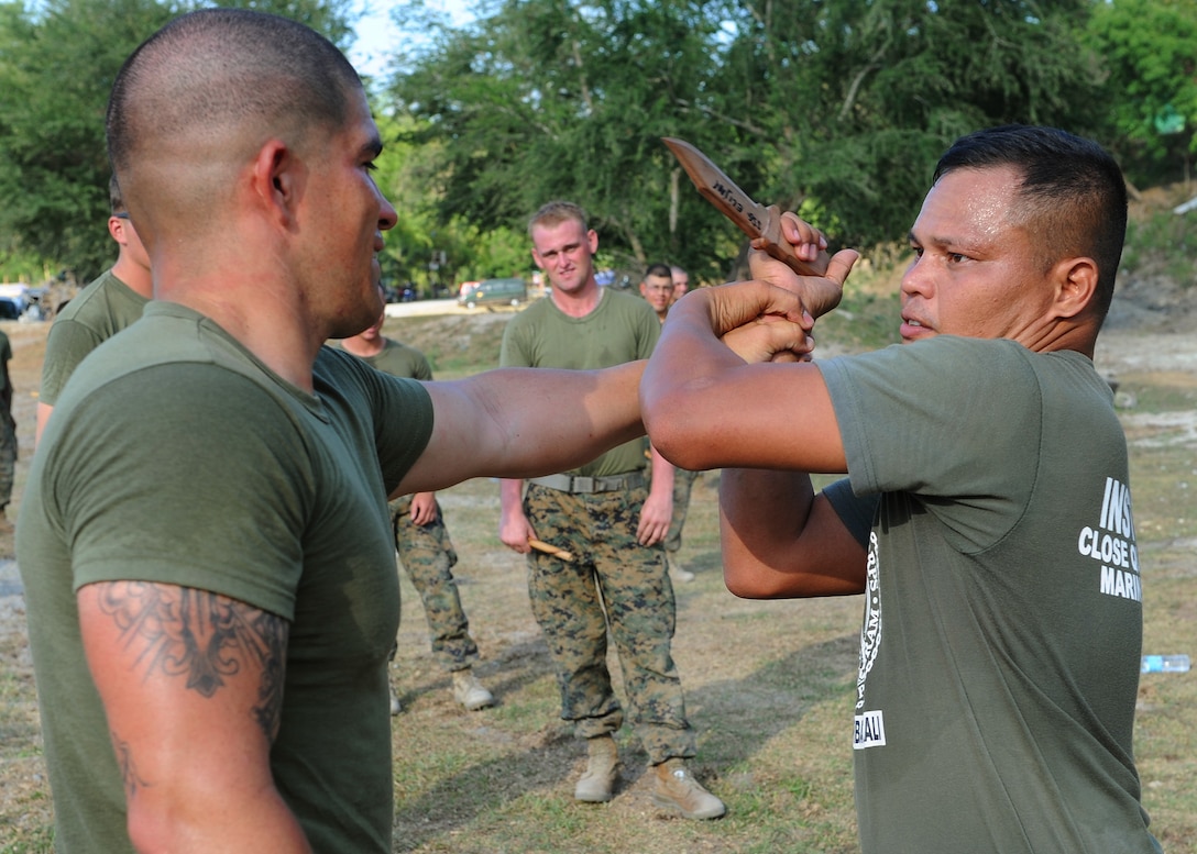 U.S. Marine Lance Cpl. Alphoso Cuomo, an infantryman with 3rd Battalion, 6th Marine Regiment, 2nd Marine Division, II Marine Expeditionary Force, blocks a wooden knife strike from Philippine Marine Staff Sgt. Renante Armamento, a Davao City native and close quarters martial arts instructor. Armanento explains defensive fighting techniques to U.S. Marines with 3rd Battalion, 6th Marine Regiment, 2nd Marine Division, II Marine Expeditionary Force, during a martial arts bilateral expertise exchange at Crow Valley, Philippines, as part of Balikatan 2013, an annual bilateral training exercise currently in its 29th iteration. BK13 is designed to enhance interoperability between both forces and strengthen military-to-military relations.