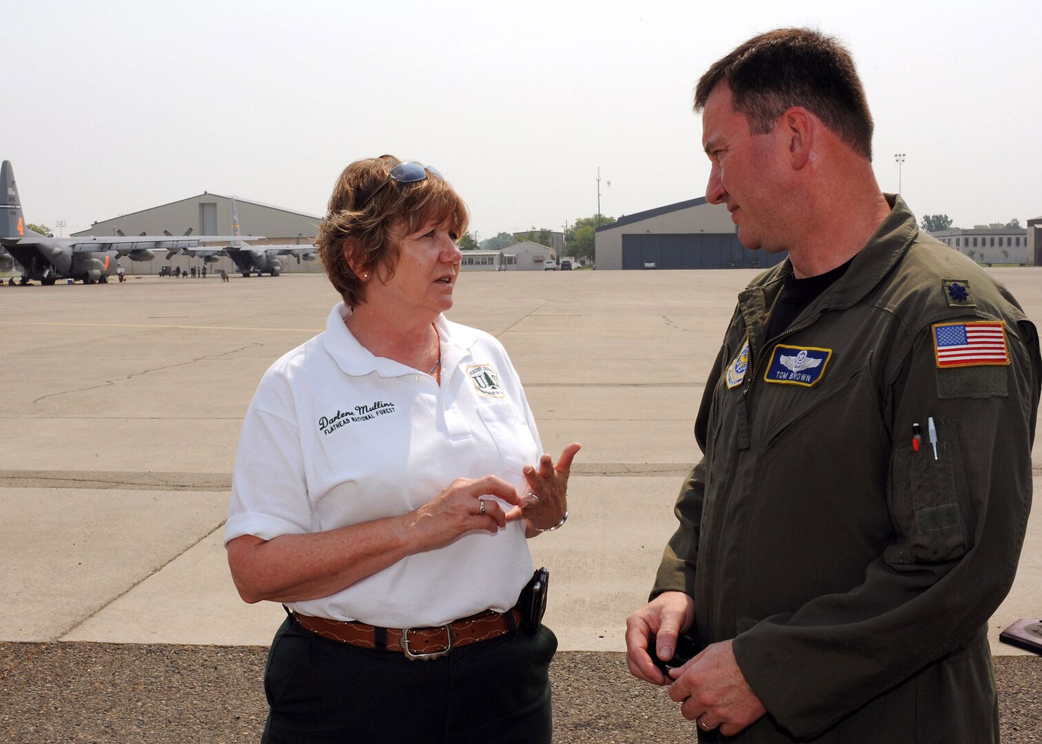 Darlene Mullins discusses upcoming firefighting missions with Lt. Col. Tom Brown July 6 at McClellan Airfield, Calif. Ms. Mullins is a Modular Airborne Firefighting System liaison officer for the U.S. Forest Service. Colonel Brown is the commander of the 145th Air Expeditionary Squadron of the North Carolina Air National Guard.