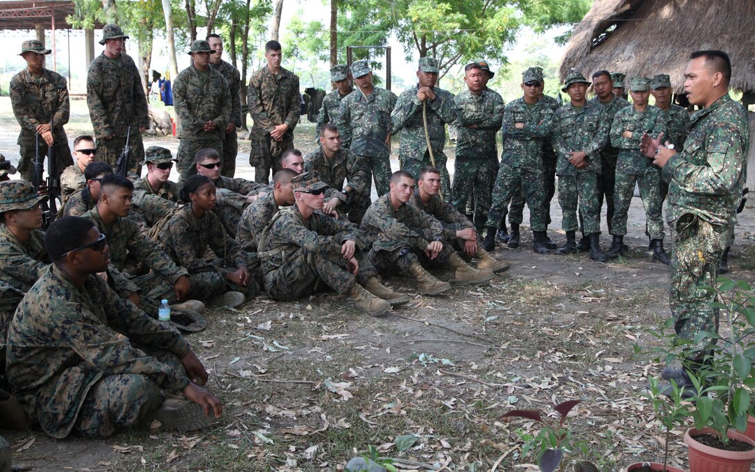 Philippine Marine Sgt. Bimbo R. Busico explains survival skills to Armed Forces of the Philippines and U.S. Marines during basic jungle survival training April 8 at Camp O'Donnell, Philippines. The survival training is part of Balikatan 2013, an annual bilateral exercise in its 29th iteration, which provides a venue for AFP and U.S. military forces to develop and continue to enhance interoperability across a wide range of military actions. "The survival training is to instruct the Marines on the basic skills to survive in a jungle setting," said Busico. "They learned how to make traps and snares, produce fire using bamboo, create a shelter, and find food." Busico is an instructor with Force Reconnaissance Battalion, AFP.