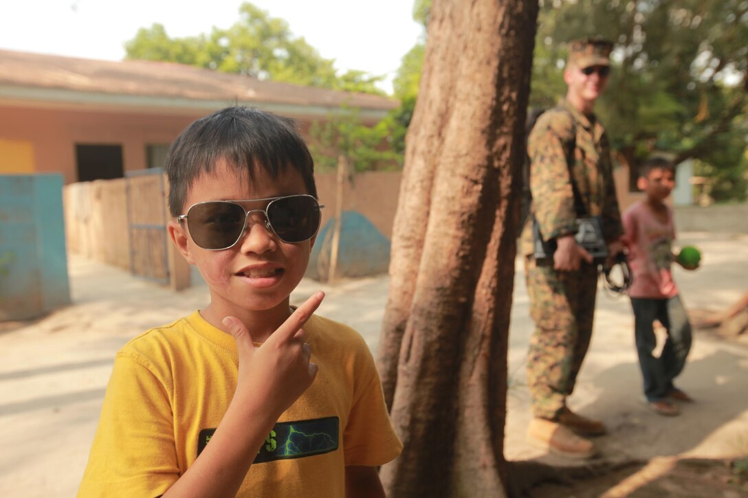 A Filipino from the Shepherd of the Hills Children's Foundation poses for a photo during a Community Relations project (COMREL) April 12, 2013. The COMREL was one of several scheduled by Joint Civil Military Operations Task Force (JCMOTF) units in support of exercise Balikatan 2013. Balikatan is an annual Republic of the Philippines-U.S. military bilateral training exercise and humanitarian assistance engagement.
